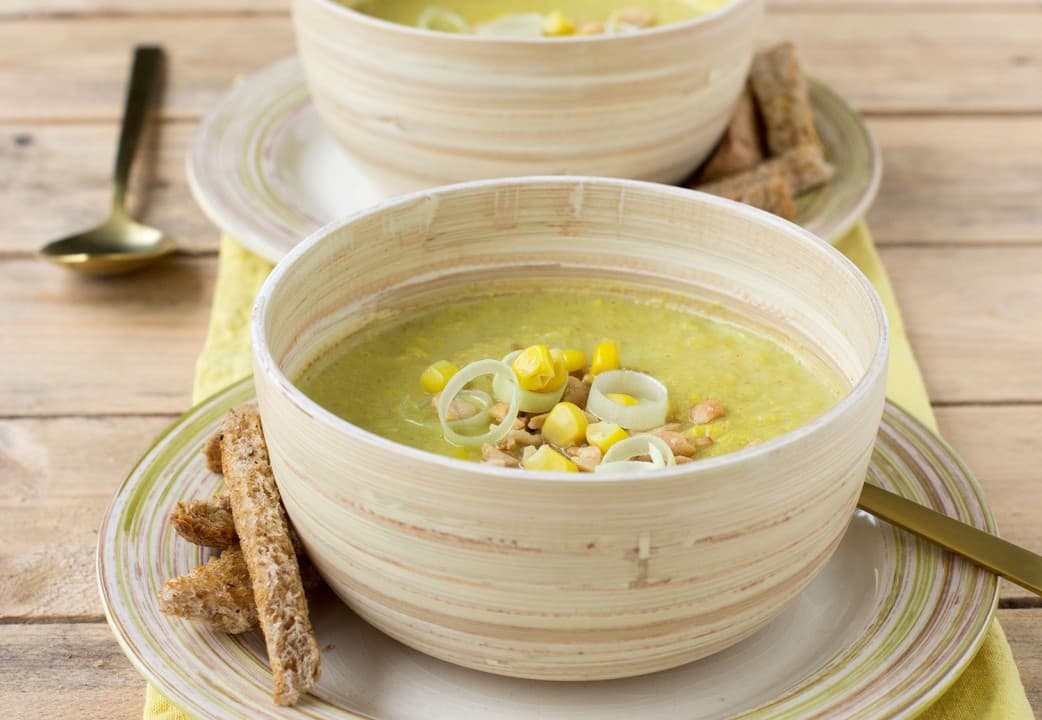 Corn chowder with spicy bread bars and peanuts