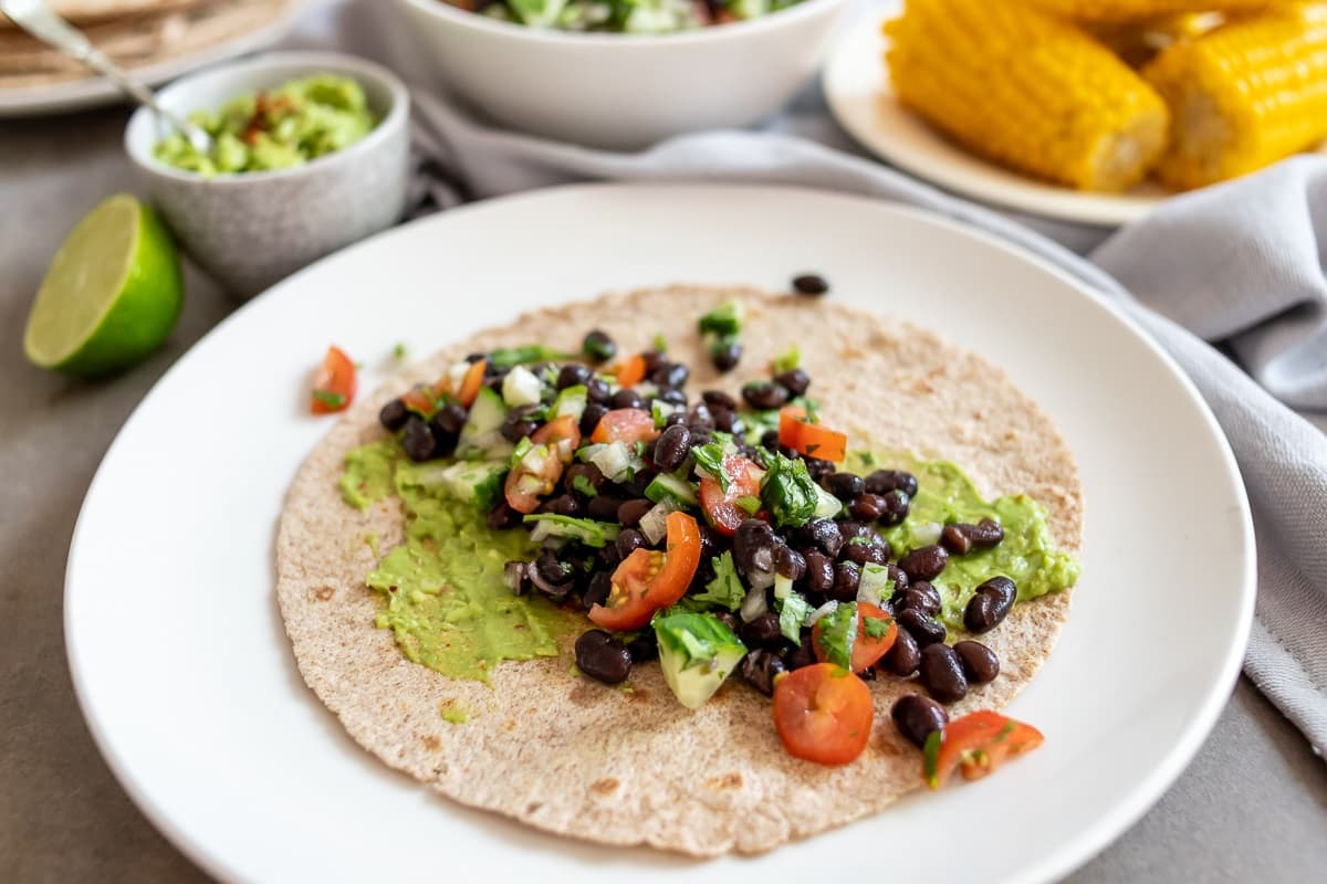 Whole-wheat wraps with beans, guacamole and corn by Francesca Kookt