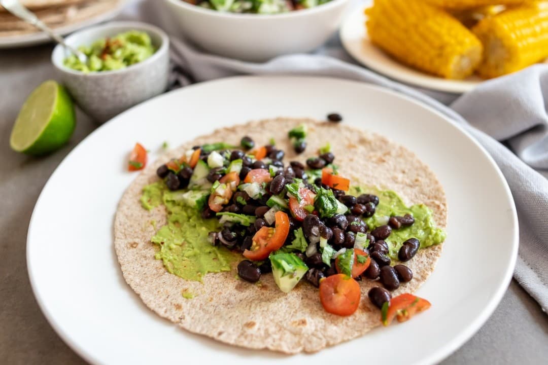 Whole-wheat wraps with beans, guacamole and corn by Francesca Kookt